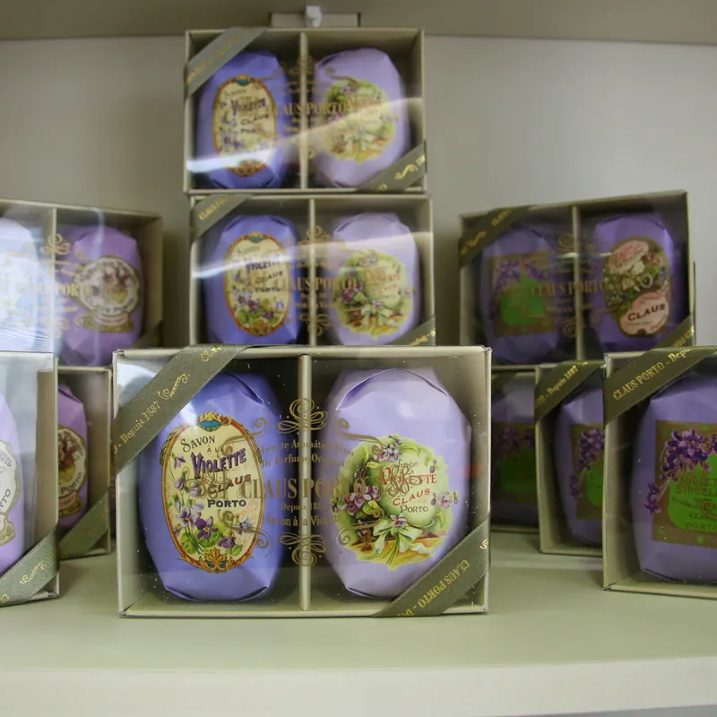 Claus Porto soaps wrapped in illustrated paper, boxed on a shop shelf